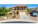 Two-story home featuring desert landscaping, balcony, and a two-car garage at 7039 W Katharine Way, Peoria, AZ 85383