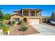 Charming two-story home featuring a well-manicured front yard and a spacious two-car garage at 7039 W Katharine Way, Peoria, AZ 85383