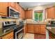Close-up of the kitchen showcasing granite counters, modern appliances, and updated cabinets at 7039 W Katharine Way, Peoria, AZ 85383