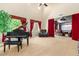 Spacious living room featuring plush carpet, tall ceilings, and a grand piano at 7039 W Katharine Way, Peoria, AZ 85383