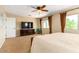 Inviting main bedroom with a large window, TV, and a comfortable king size bed at 7039 W Katharine Way, Peoria, AZ 85383