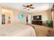 Comfortable main bedroom featuring ensuite bathroom access, TV, and a large window at 7039 W Katharine Way, Peoria, AZ 85383