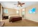 Spacious main bedroom boasting carpet floors and a leather storage bench at 7039 W Katharine Way, Peoria, AZ 85383