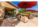 Covered patio area featuring an outdoor kitchen and barbecue, perfect for outdoor entertaining and relaxation at 7039 W Katharine Way, Peoria, AZ 85383