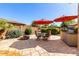 Enjoy this expansive outdoor patio with a dining area, barbecue, and fire pit, ideal for entertaining guests at 7039 W Katharine Way, Peoria, AZ 85383