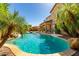 Relaxing pool area with a sparkling pool, lush palms, and covered patio, perfect for outdoor entertaining and relaxation at 7039 W Katharine Way, Peoria, AZ 85383