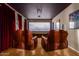 Inviting home theater with comfortable leather chairs and a large projection screen at 7039 W Katharine Way, Peoria, AZ 85383