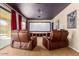 Comfortable home theater with reclining seats, a projector, and large screen at 7039 W Katharine Way, Peoria, AZ 85383