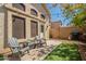 Cozy backyard featuring artificial grass, patio, outdoor grill, and charming patio furniture at 7227 E Kramer St, Mesa, AZ 85207