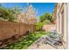 Charming backyard featuring artificial turf, a lush tree, string lights, and inviting patio furniture at 7227 E Kramer St, Mesa, AZ 85207