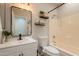 Well-lit bathroom with vanity, storage shelves, and shower-tub combination at 7227 E Kramer St, Mesa, AZ 85207