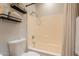 Clean bathroom with tiled shower/tub combo and functional shelving for storage at 7227 E Kramer St, Mesa, AZ 85207