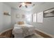 Cozy bedroom featuring a ceiling fan, natural light, and warm wood flooring at 7227 E Kramer St, Mesa, AZ 85207