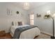 Charming bedroom with natural light, wood flooring, and decorative accents at 7227 E Kramer St, Mesa, AZ 85207