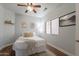 Bright bedroom with a ceiling fan, neutral decor, and an inviting window at 7227 E Kramer St, Mesa, AZ 85207