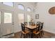 Charming dining area features a table with six chairs, a modern chandelier, and lots of natural light at 7227 E Kramer St, Mesa, AZ 85207