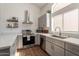Modern kitchen with stainless steel appliances, quartz countertops, and plenty of storage space at 7227 E Kramer St, Mesa, AZ 85207