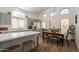 Open-concept kitchen with quartz countertops, gray cabinets, stainless steel appliances, and an adjacent dining area at 7227 E Kramer St, Mesa, AZ 85207