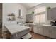 Stylish kitchen featuring stainless steel appliances, gray cabinetry, quartz countertops, and ample natural light at 7227 E Kramer St, Mesa, AZ 85207