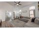 Spacious living room showing vaulted ceilings, comfortable seating, and view into the primary bedroom at 7227 E Kramer St, Mesa, AZ 85207