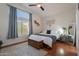 Bright main bedroom with a decorative rug, window, and chest at the foot of the bed at 7227 E Kramer St, Mesa, AZ 85207