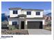 A two-story home with a two-car garage, showcasing a modern design and mountain views at 7385 W Buckhorn Trl, Peoria, AZ 85383