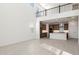 Open-concept living room with plenty of natural light, a modern kitchen, and stylish flooring at 7385 W Buckhorn Trl, Peoria, AZ 85383