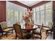 Traditional dining room with a chandelier over a round table, and many windows at 742 W Puget Ave, Phoenix, AZ 85021
