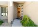 Home front entrance features a wooden door with sidelights, rock landscaping, and a window with shutters at 742 W Puget Ave, Phoenix, AZ 85021