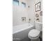 Bright bathroom with white tiled walls, soaking tub, and modern fixtures at 7590 W Firebird Dr, Glendale, AZ 85308