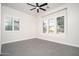 This bedroom features tile flooring, ceiling fan, and white plantation shutters at 7590 W Firebird Dr, Glendale, AZ 85308