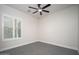 Empty bedroom featuring a ceiling fan and window with white shutters at 7590 W Firebird Dr, Glendale, AZ 85308