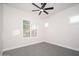 Empty bedroom with two windows offering natural light, complemented by a ceiling fan at 7590 W Firebird Dr, Glendale, AZ 85308