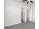 This bedroom features neutral walls, tile flooring, closet, and ceiling fan at 7590 W Firebird Dr, Glendale, AZ 85308