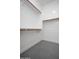 Walk-in closet with chrome rods, shelving, and tile flooring at 7590 W Firebird Dr, Glendale, AZ 85308
