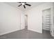 Neutral room showing tile flooring, an open doorway, and a walk-in closet at 7590 W Firebird Dr, Glendale, AZ 85308