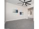 Empty room with gray tile flooring, ceiling fan, and an open doorway at 7590 W Firebird Dr, Glendale, AZ 85308