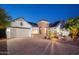 Charming single-Gathering home featuring desert landscaping, solar panels, and a paver driveway at 7590 W Firebird Dr, Glendale, AZ 85308