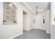 Bright foyer featuring tile flooring, modern light fixtures, and decorative art niches at 7590 W Firebird Dr, Glendale, AZ 85308