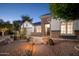 Gorgeous home featuring stone accents, desert landscaping, and a charming brick pathway leading to the entrance at 7590 W Firebird Dr, Glendale, AZ 85308