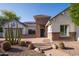 Charming home showcasing desert landscaping, stone accents, and a brick pathway leading to the entrance at 7590 W Firebird Dr, Glendale, AZ 85308