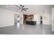 Open-concept living room with tile floors, a ceiling fan, and easy access to the kitchen and backyard at 7590 W Firebird Dr, Glendale, AZ 85308