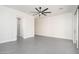 Large bedroom with a modern ceiling fan, neutral paint, and an open door to the ensuite bathroom at 7590 W Firebird Dr, Glendale, AZ 85308