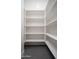 A well-organized, walk-in pantry features multiple shelves for storage at 7590 W Firebird Dr, Glendale, AZ 85308