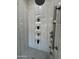Modern shower with gray tile, showerhead, shelving and beautiful decorative plants at 7590 W Firebird Dr, Glendale, AZ 85308