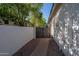 Gated side yard with gravel and brick pathway, perfect for extra storage or a pet run at 7590 W Firebird Dr, Glendale, AZ 85308