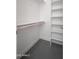 Walk-in closet with white shelving and rod for hanging clothes at 7590 W Firebird Dr, Glendale, AZ 85308