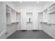 Bright, spacious walk-in closet with custom shelving and drawers at 7590 W Firebird Dr, Glendale, AZ 85308