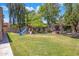 Lush backyard with playset, slide, and manicured lawn at 7758 E Nestling Way, Scottsdale, AZ 85255