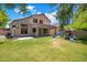 Large backyard with green grass, patio, a playground, and a basketball hoop at 7758 E Nestling Way, Scottsdale, AZ 85255